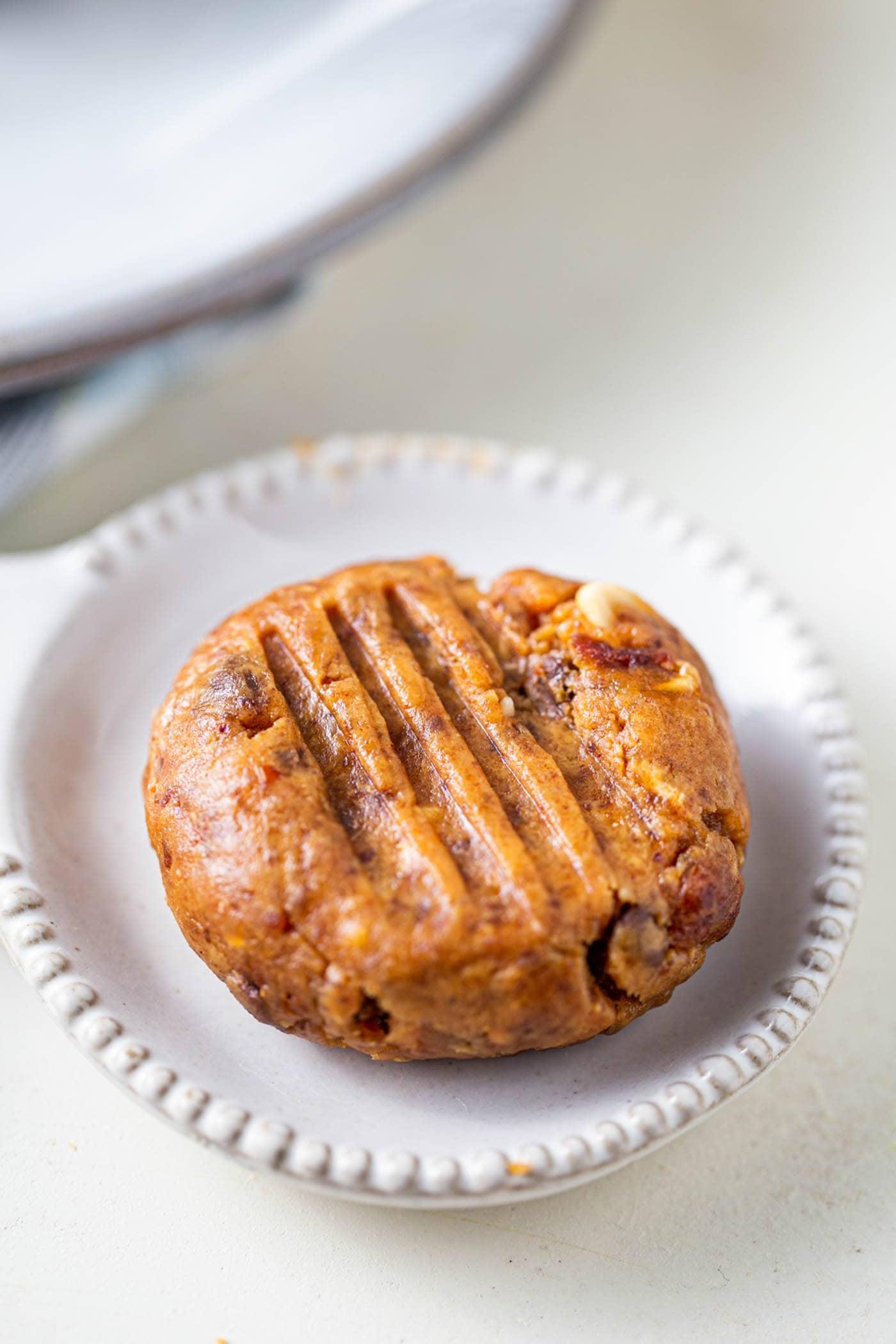 A no-bake peanut butter chocolate chip cookie on a small white plate.
