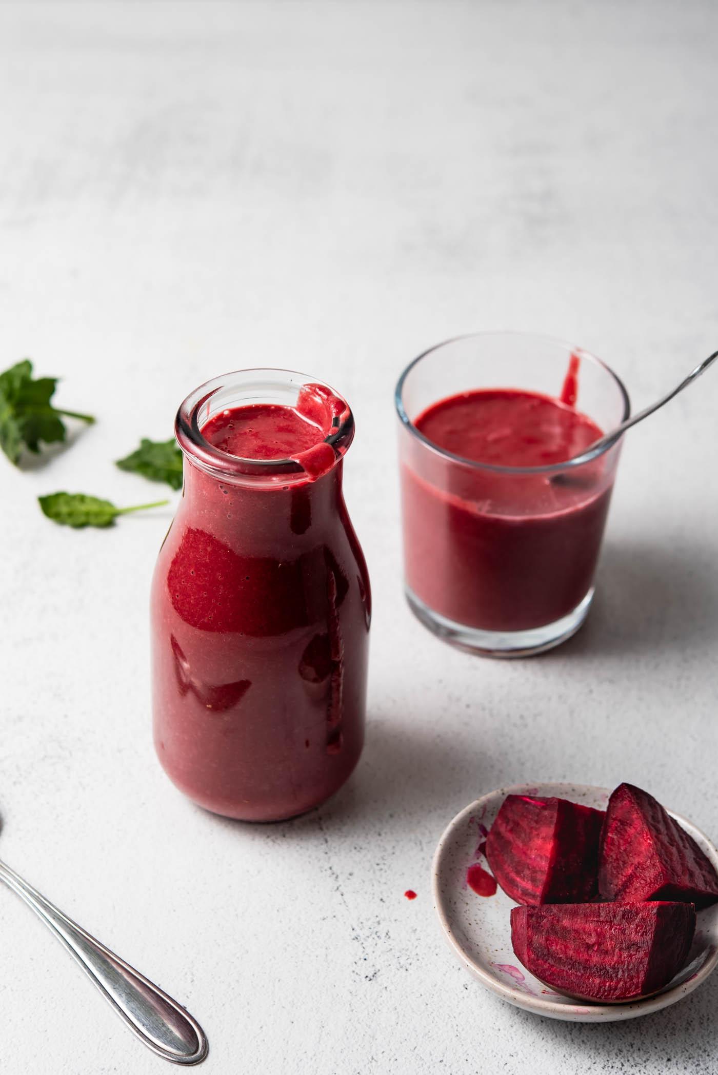 Beet Lemoen Smoothie 2 Beet smoothie in a jar with another small glass behind it and a small dish of chopped beets beside it.