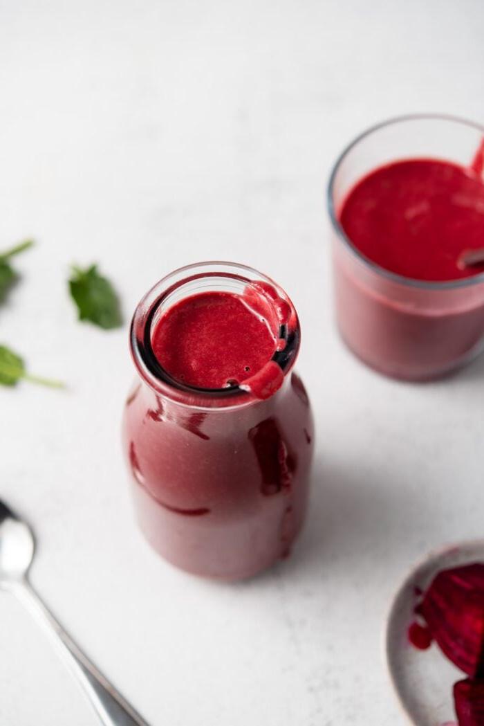 Beet Lemoen Smoothie 4 Beet smoothie in a jar with another small glass behind it and a small dish of chopped beets beside it.