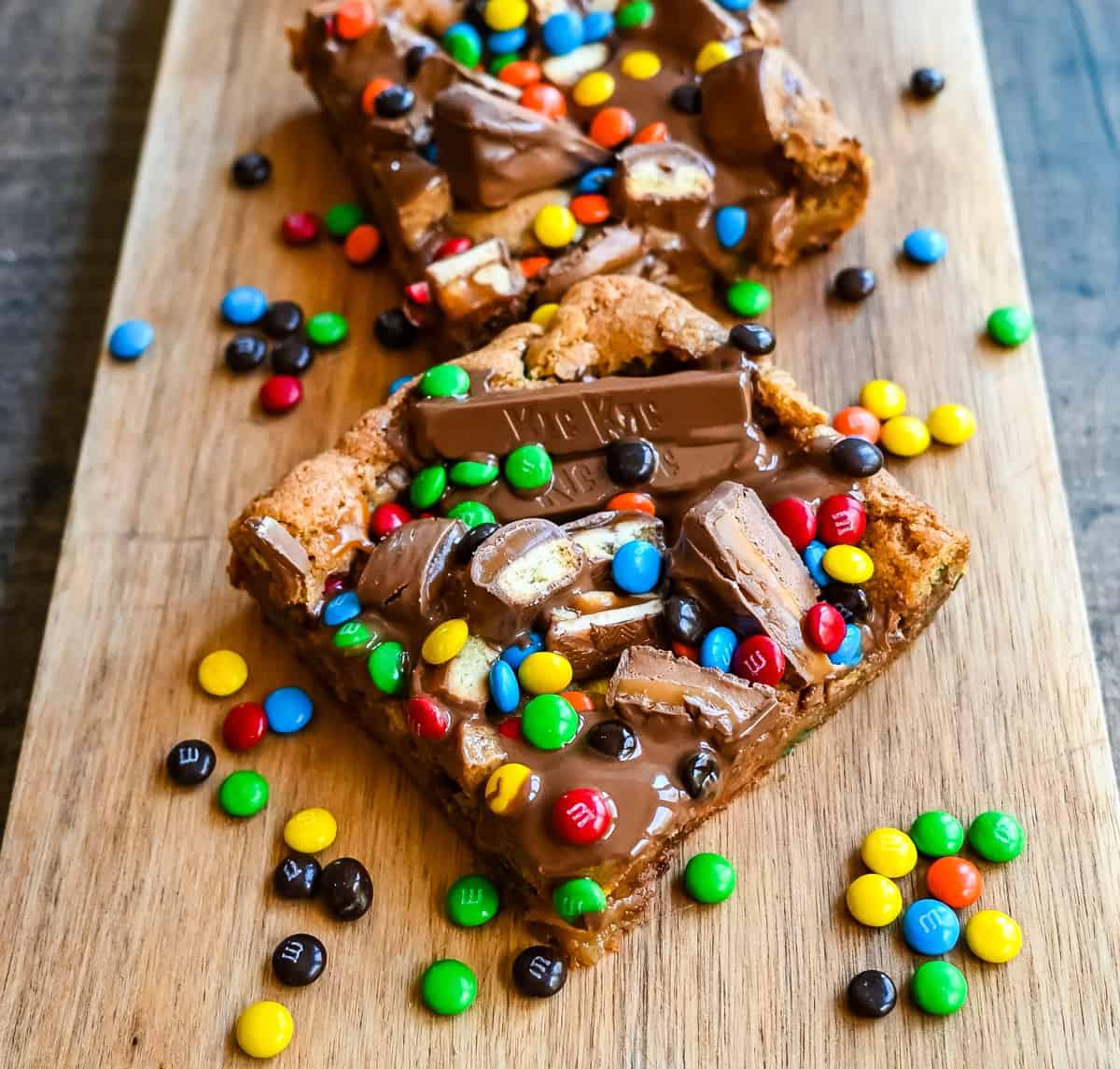 Candy Bar Μπάρες Μπισκότου 5 Μια απίστευτα μαλακή και ζουμερή μπάρα μπισκότου, γεμάτη με ποικιλία από σοκολάτες. Το τέλειο γλυκό blondie για να φτιάξετε με τις σοκολάτες του Halloween.