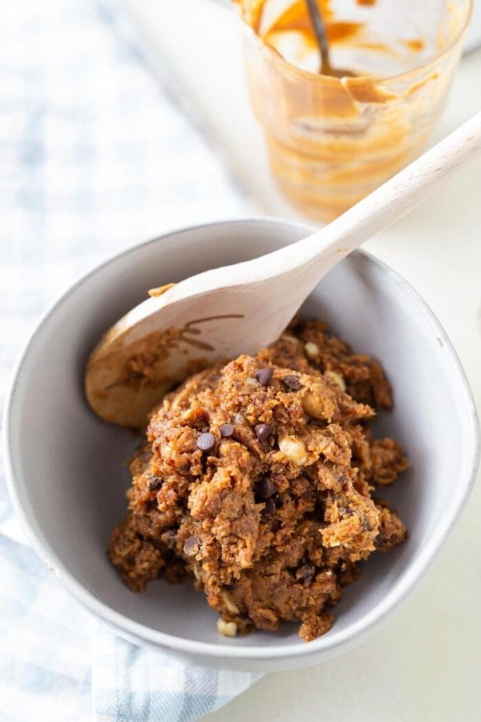 Raw chocolate chip cookie dough in a small bowl.