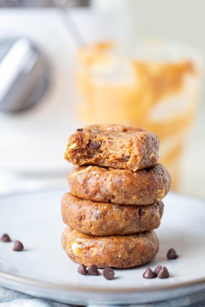 A stack of 4 no-bake cookies on a white plate.