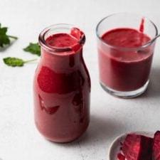Beet Lemoen Smoothie 7 Beet smoothie in a jar with another small glass behind it and a small dish of chopped beets beside it.