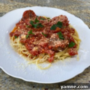 Rich homemade marinara sauce simmering in a Dutch oven, ready for freezing.