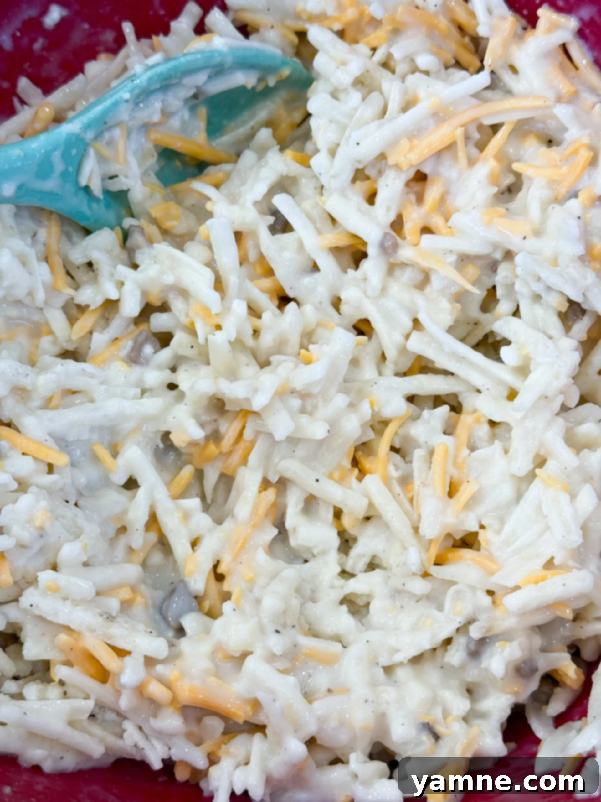 Mixing hashbrown mixture with cheese and soup