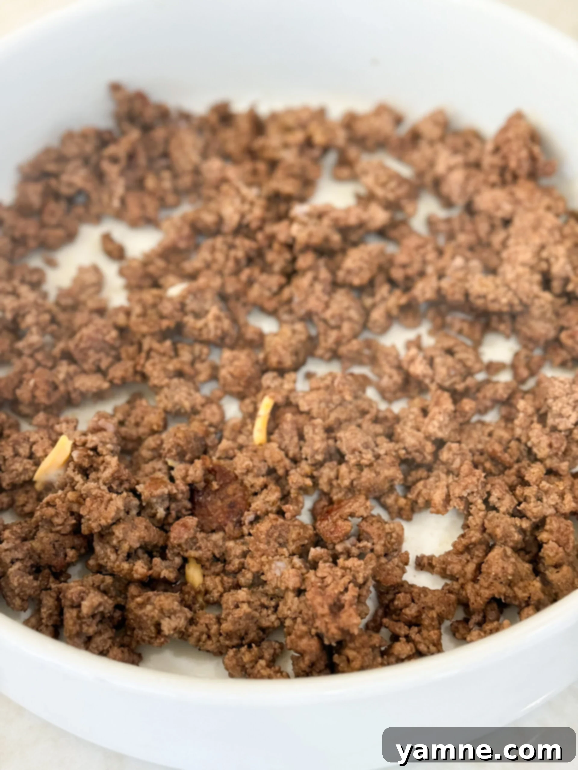 Browned ground beef added to bottom of casserole dish