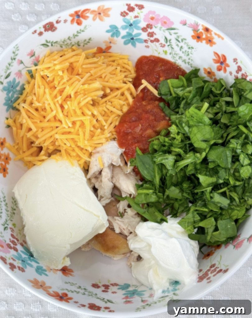 Crispy Cheesy Chicken Taquitos 3 mixing cheesy chicken taquito ingredients in a bowl