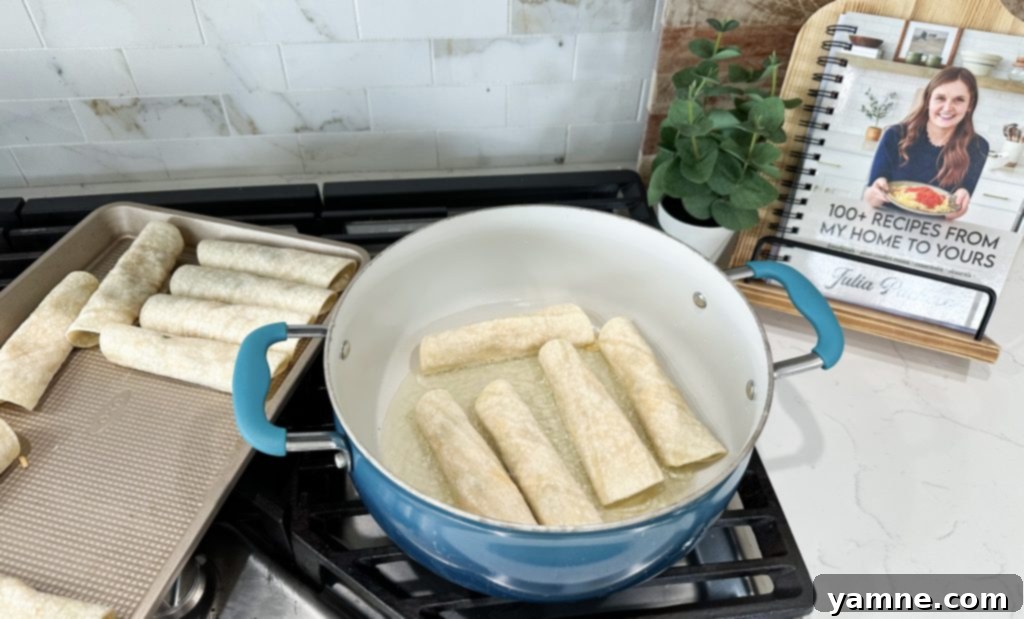 Crispy Cheesy Chicken Taquitos 6 frying cheesy chicken taquitos in a hot pan