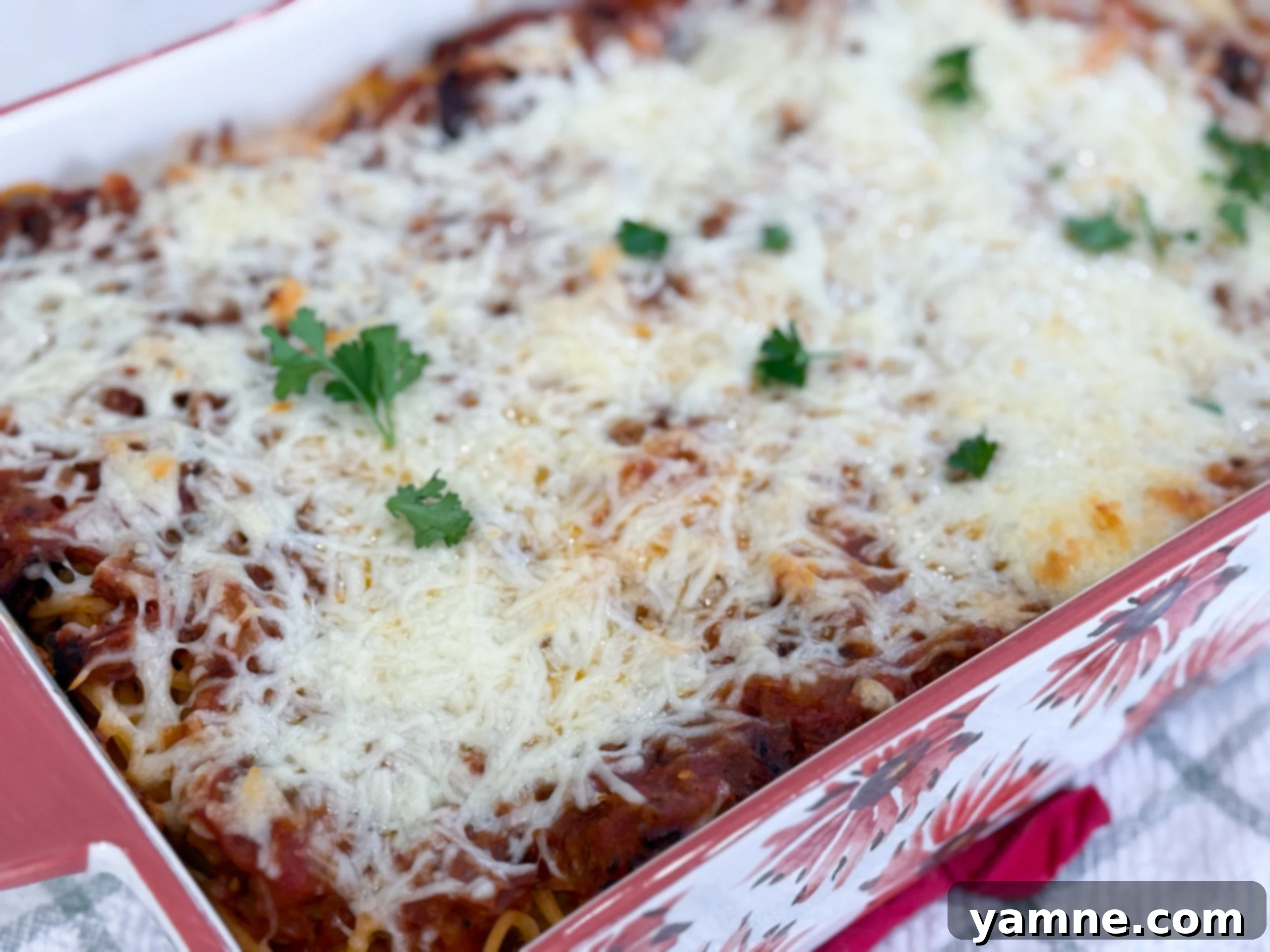 Million Dollar Spaghetti baked in a casserole dish with golden melted cheese on top.