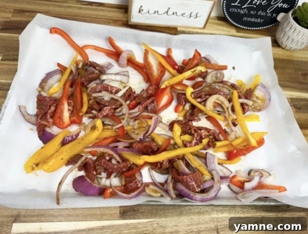 Steak and veggie mixture for sheet pan fajitas