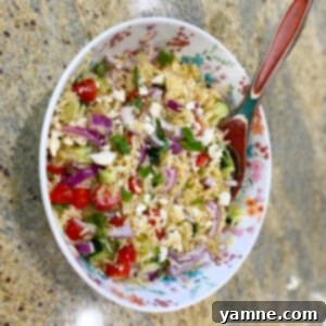Vibrant Orzo Feta Pasta Salad with cherry tomatoes, cucumber, red onion, and fresh basil