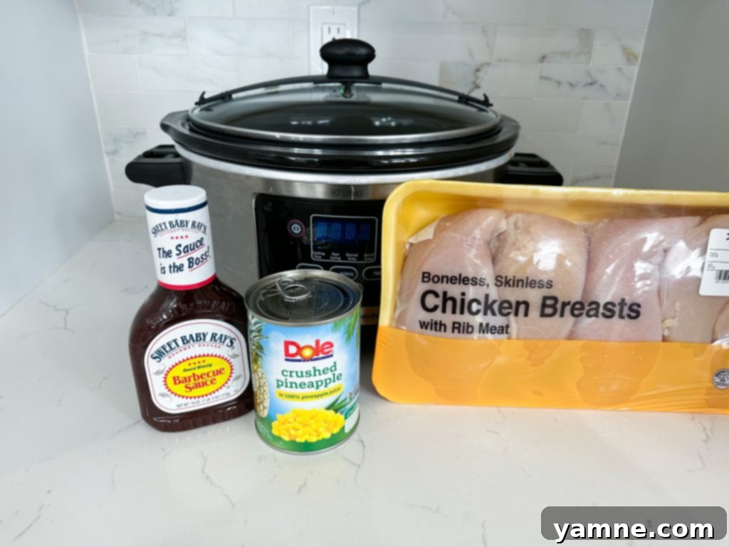 Slow Cooker Pineapple Barbecue Chicken served over rice with fresh herbs.