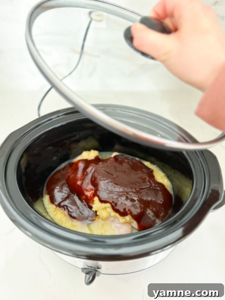 Close-up of ingredients for Slow Cooker Pineapple Barbecue Chicken including chicken, pineapple, and sauces.