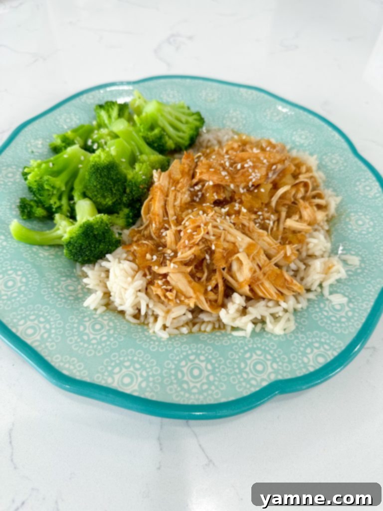 Close-up of shredded Slow Cooker Pineapple Barbecue Chicken in a crockpot.