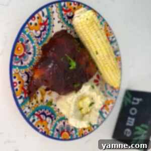 Slow Cooker BBQ Ribs 2 Juicy, tender slow cooker barbecue ribs on a plate with barbecue sauce