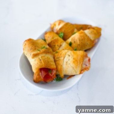 Pizza Crescent Pockets 2 Golden baked pizza crescent pockets filled with cheese and pepperoni