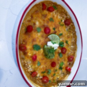 Close-up of baked Salsa Verde Chicken Casserole with melted cheese and fresh cilantro garnish