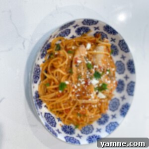 One-Pot Burst Tomato Feta Chicken Pasta 2 Delicious One-Pot Tomato Chicken Feta Pasta, garnished with fresh basil, ready to be served from a large pot.