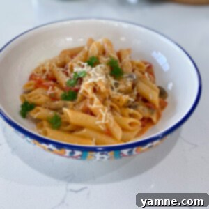 A vibrant bowl of creamy Cajun veggie pasta, rich with colorful vegetables and a hint of spice.