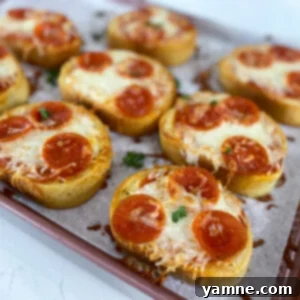 Crispy homemade garlic bread pizzas topped with melted cheese and pepperoni, ready to serve.
