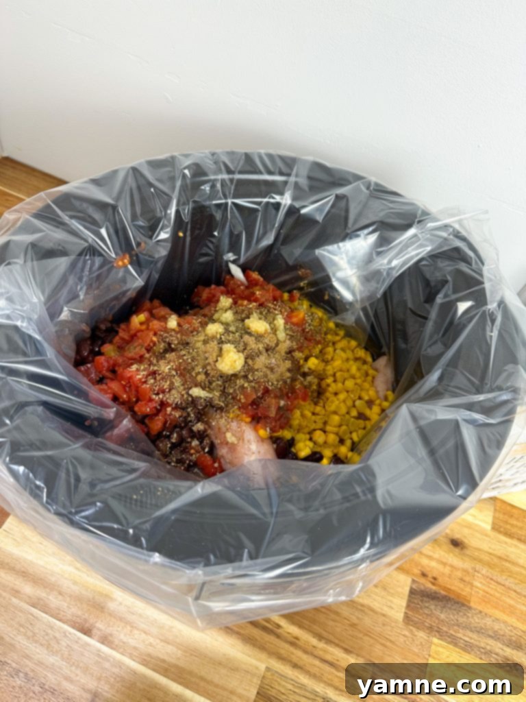 easy slow cooker chicken burrito bowl ingredients combined in a slow cooker