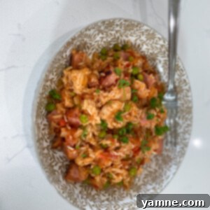 Delicious Ham, Chicken, and Rice Casserole with golden-brown crust and vibrant peas