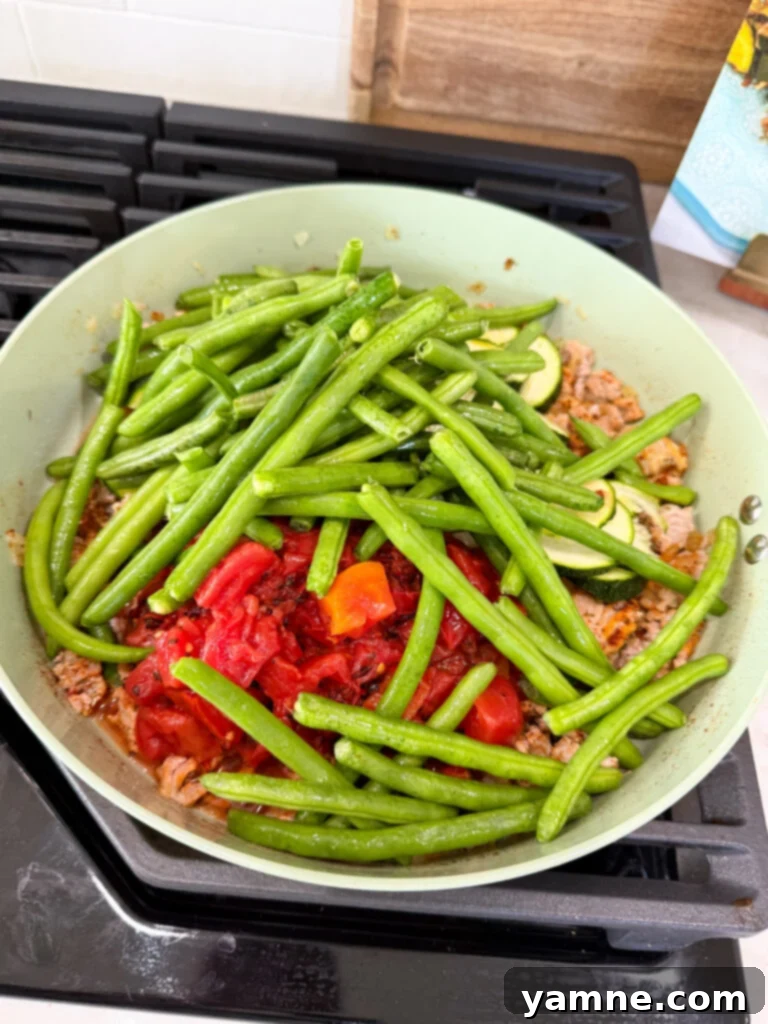 Healthy Turkey and Veggie Skillet 7 Fresh vegetables and diced tomatoes added to turkey mixture in skillet