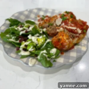 A perfectly baked Italian-Style Meatloaf topped with melted mozzarella and rich marinara sauce, garnished with fresh herbs.