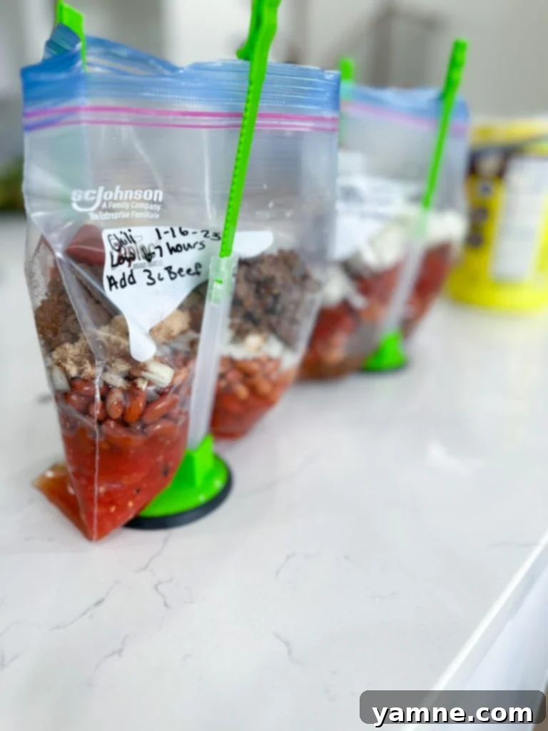 A hearty bowl of slow cooker chili topped with cheese, sour cream, and fresh cilantro, ready to be enjoyed.