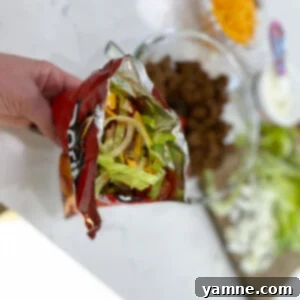 Delicious Walking Tacos served in a chip bag with fresh toppings.