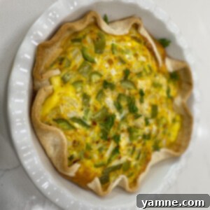 A beautifully baked vegetable quiche with a golden crust, ready to be served.