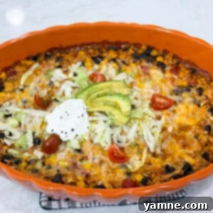 Fiesta chicken casserole baked with melted cheese and colorful toppings