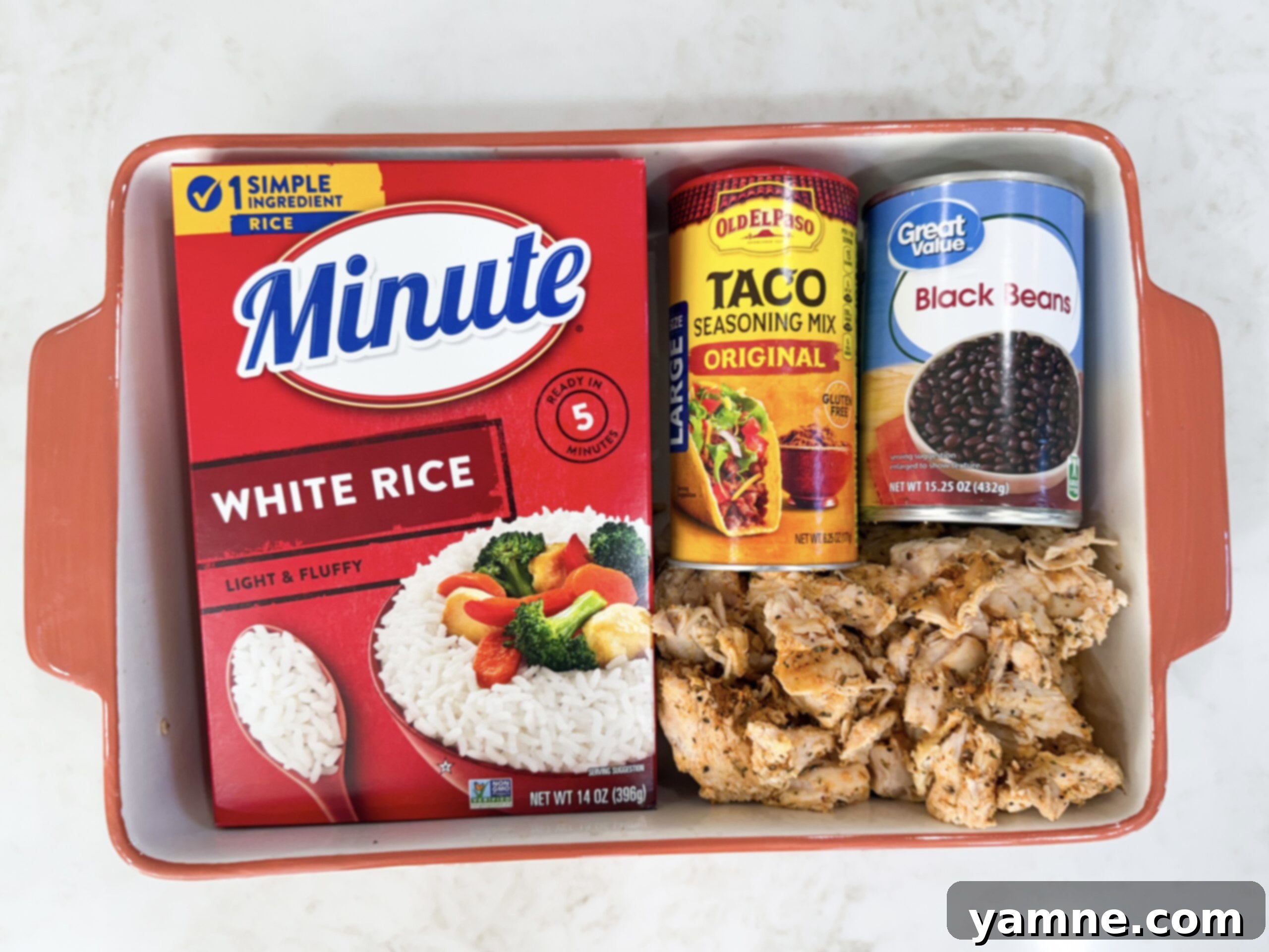 Ingredients for fiesta chicken casserole in casserole dish