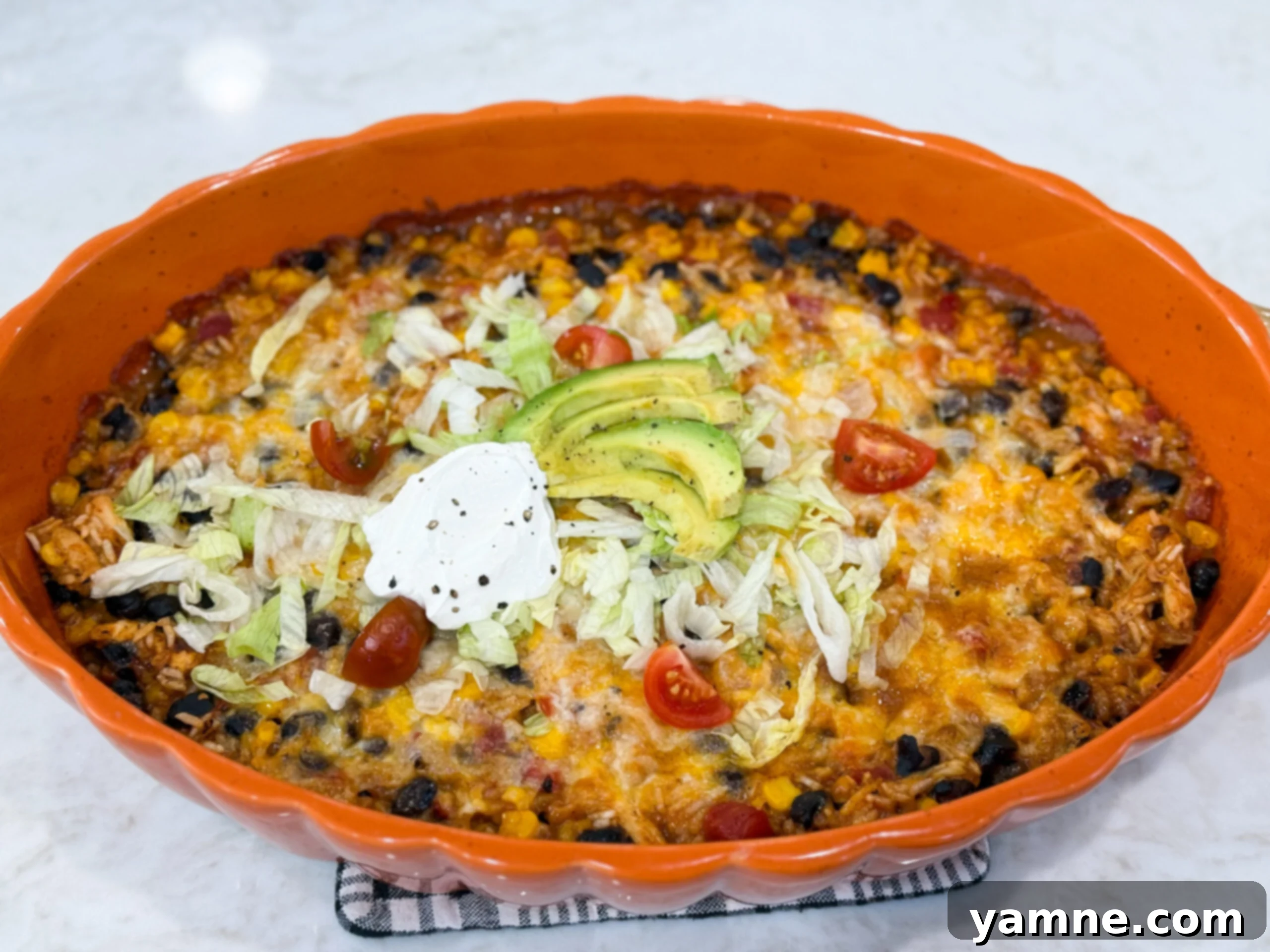 Fiesta chicken casserole baked with melted cheese and colorful toppings