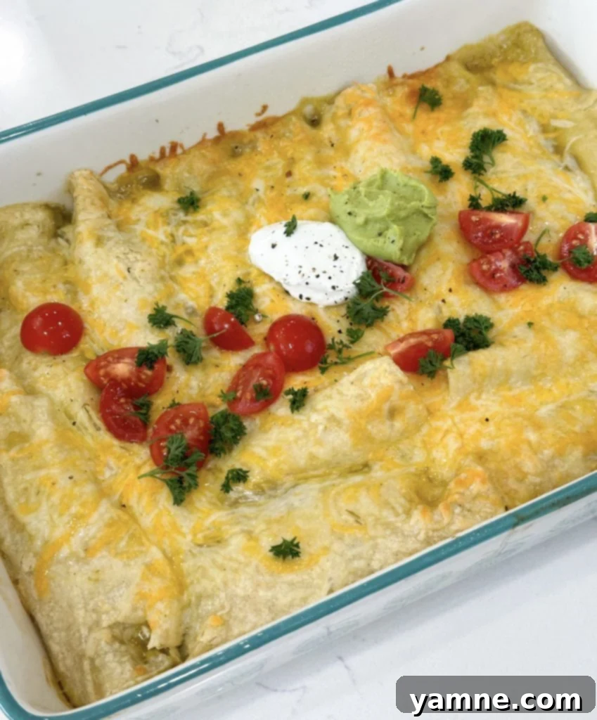 Ultimate Green Chile Chicken Enchiladas 7 Close-up of baked green chili chicken enchiladas with toppings.