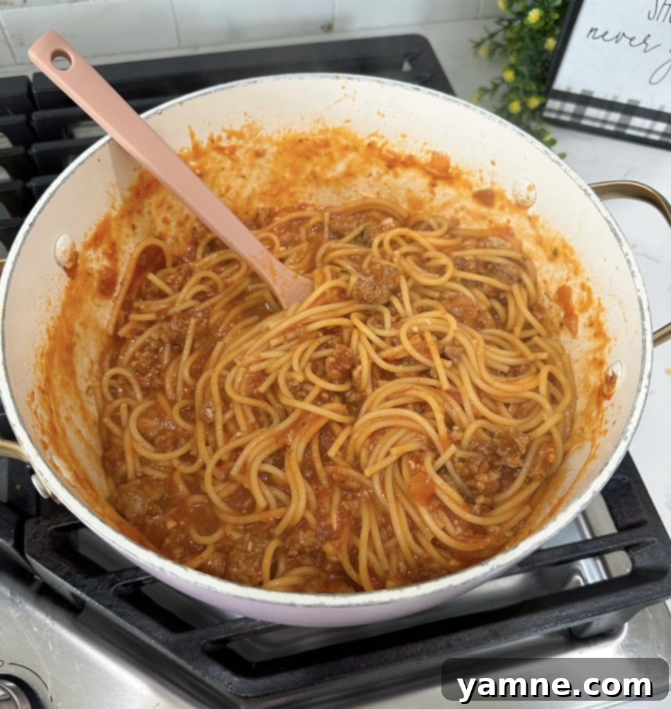 One-pot spaghetti simmering, with pasta cooking in sauce.