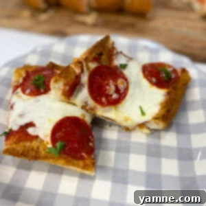 Crispy French Bread Pizzas 4 A top-down view of a freshly baked French Bread Pizza, sliced and ready to serve
