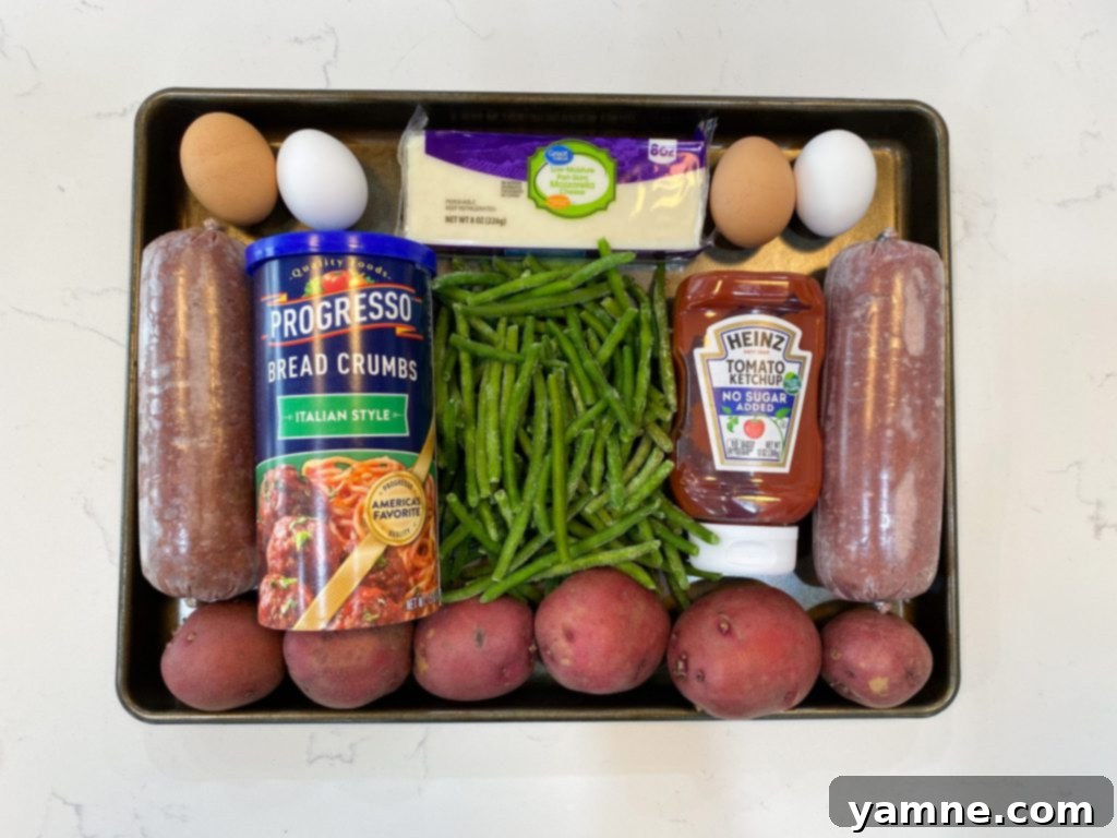 One-Pan Cheesy Stuffed Meatloaf and Roasted Veggies 2 Delicious Mozzarella Stuffed Meatloaf with roasted potatoes and green beans on a sheet pan, ready to serve.