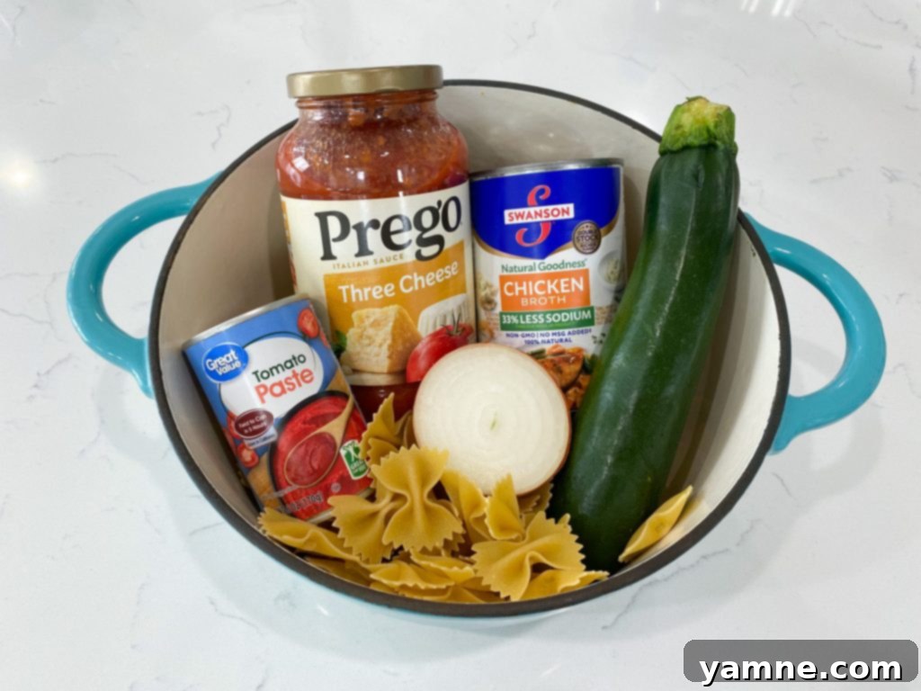One-Pan Tuscan Vegetable Pasta 2 A vibrant, close-up shot of One-Pot Italian Vegetable Pasta in a large pot, garnished with fresh herbs and melted mozzarella cheese.