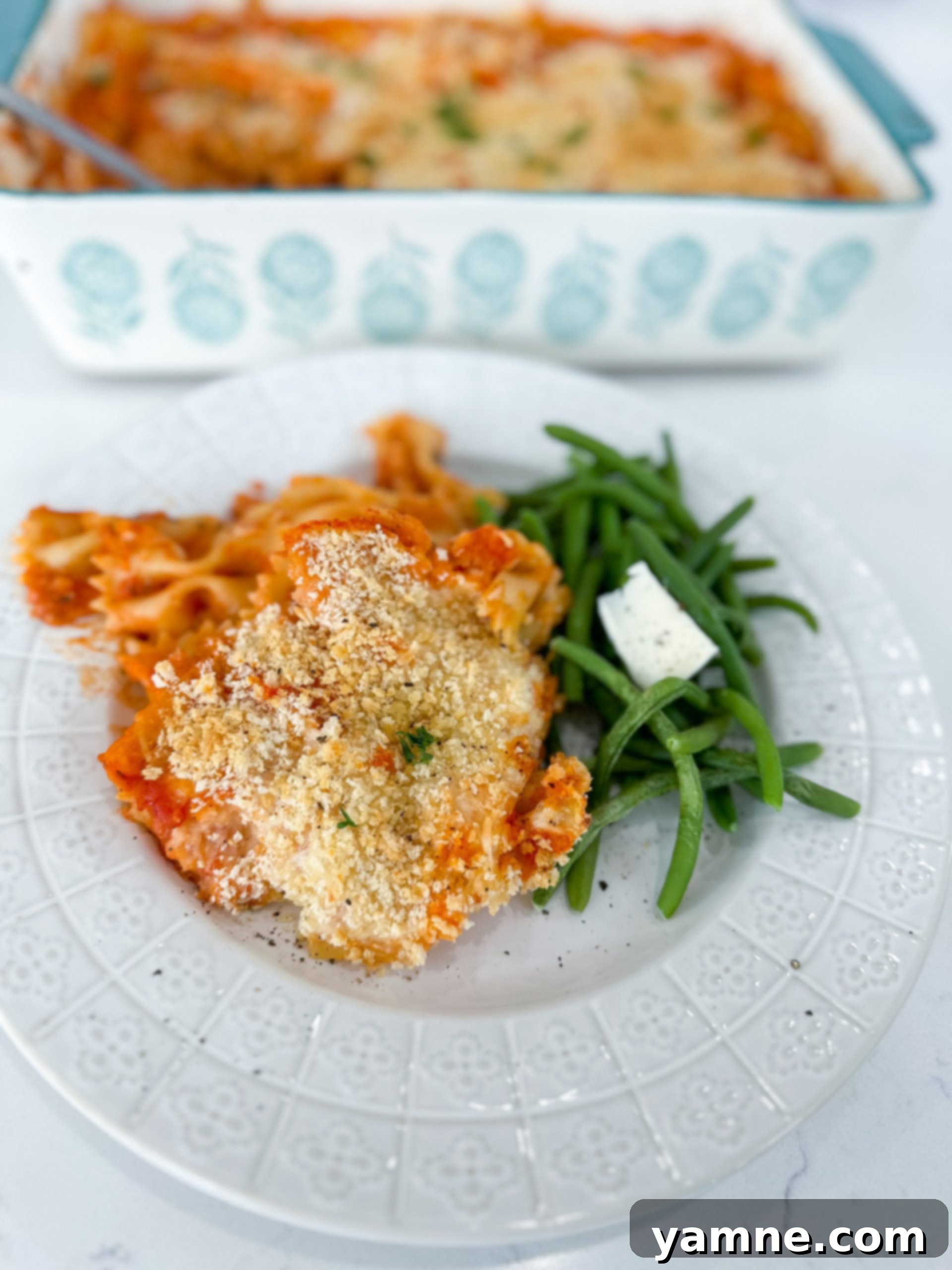 Cheesy Chicken Parm Bake 2 Baked chicken parmesan casserole topped with melted cheese and breadcrumbs