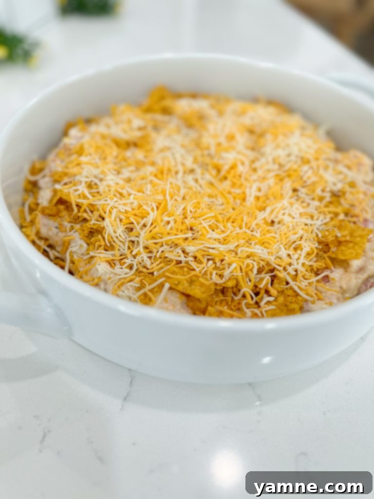 A child's hands crushing Doritos in a bag for the casserole