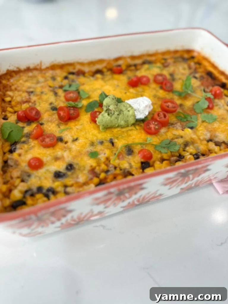 Fiesta Veggie Casserole 3 Close-up of the Vegetarian Mexican Casserole ingredients mixed in a baking dish before baking, showing colorful rice, black beans, corn, and salsa.