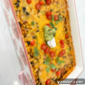 Fiesta Veggie Casserole 5 Close-up of the finished Vegetarian Mexican Casserole, cheesy and golden brown, ready to be scooped.