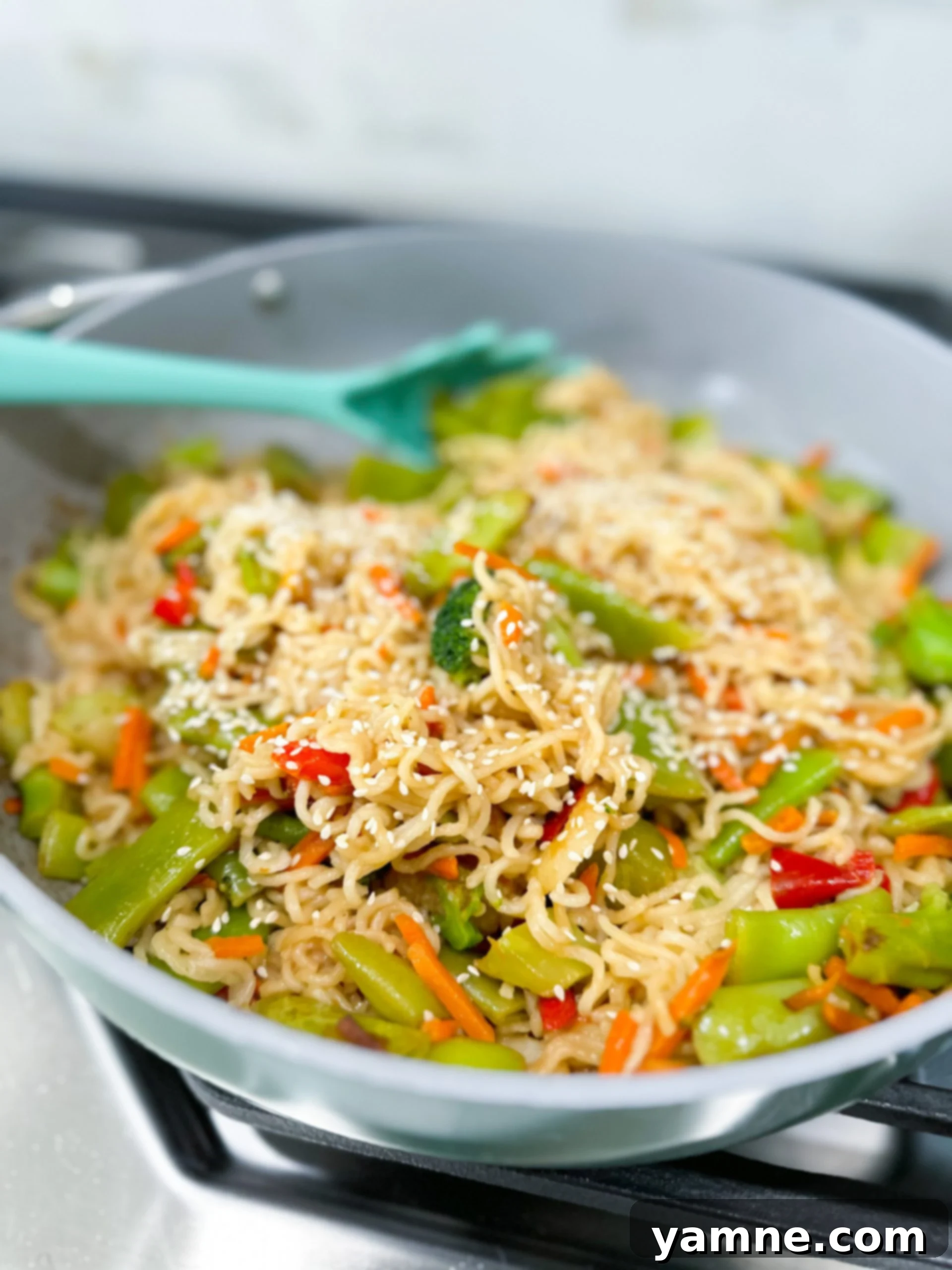 Colorful ramen noodle stir fry with vegetables in skillet, ready to serve