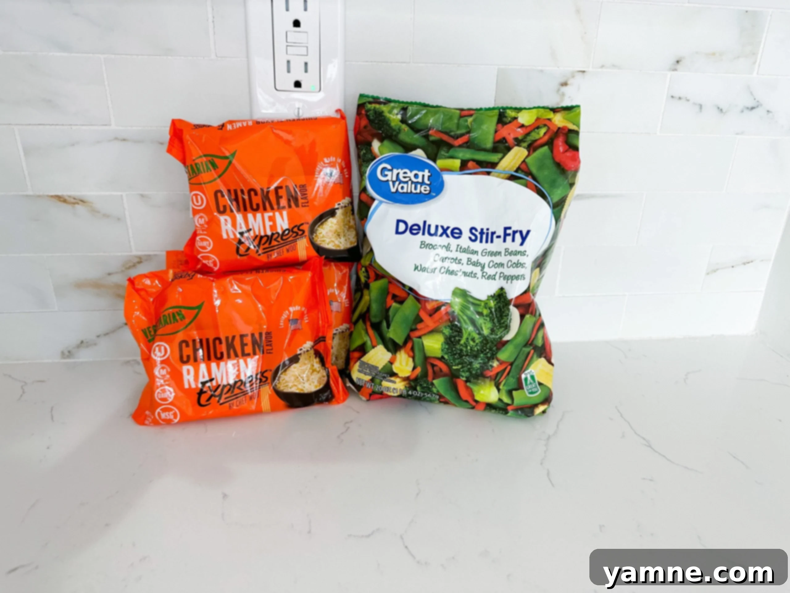 Ingredients for ramen noodle stir fry including noodles, frozen mixed vegetables, and soy sauce on a wooden board