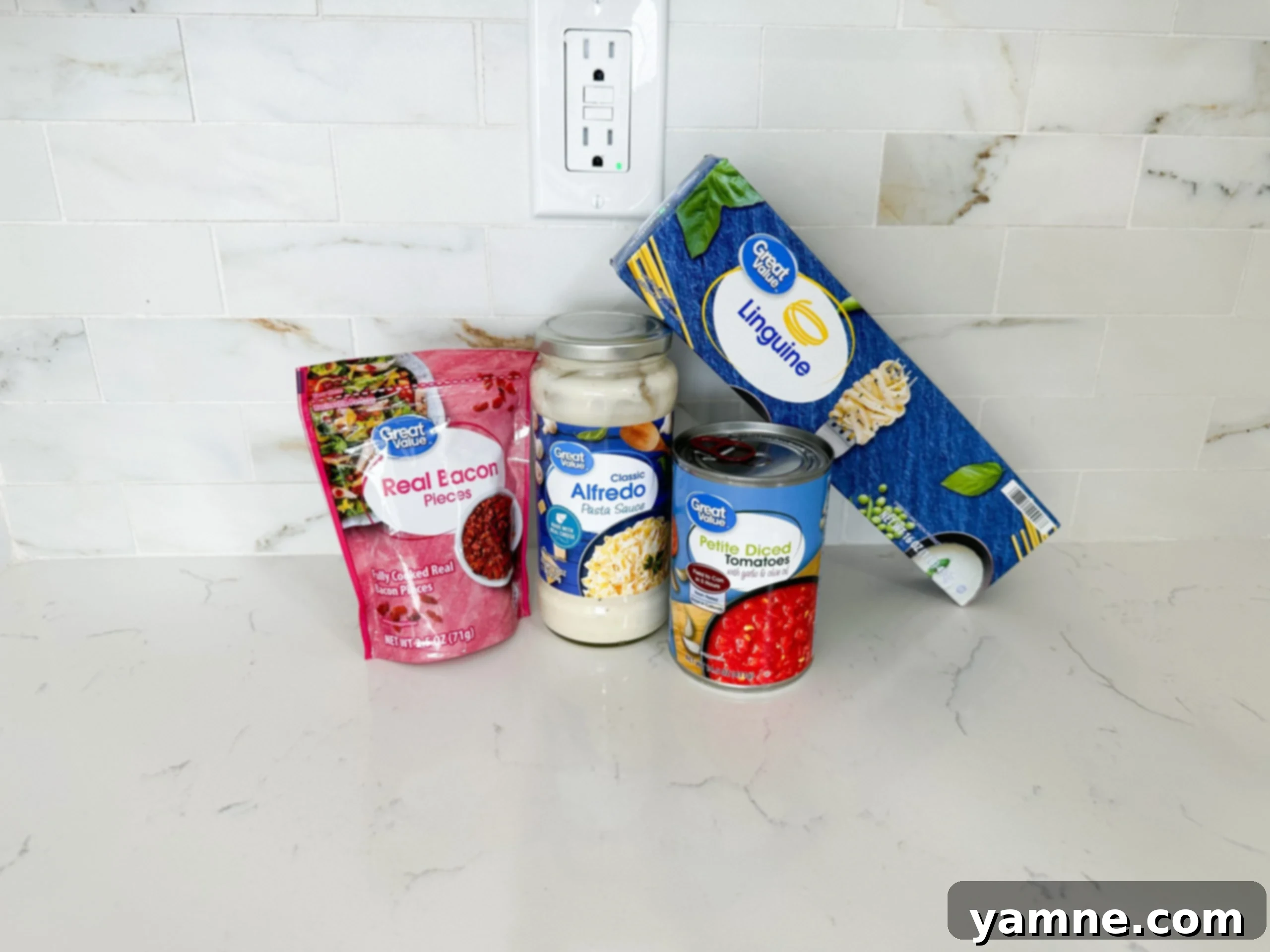 Smoky Bacon Tomato Cream Pasta 5 Ingredients for creamy tomato bacon pasta including pasta, Alfredo sauce, and bacon bits