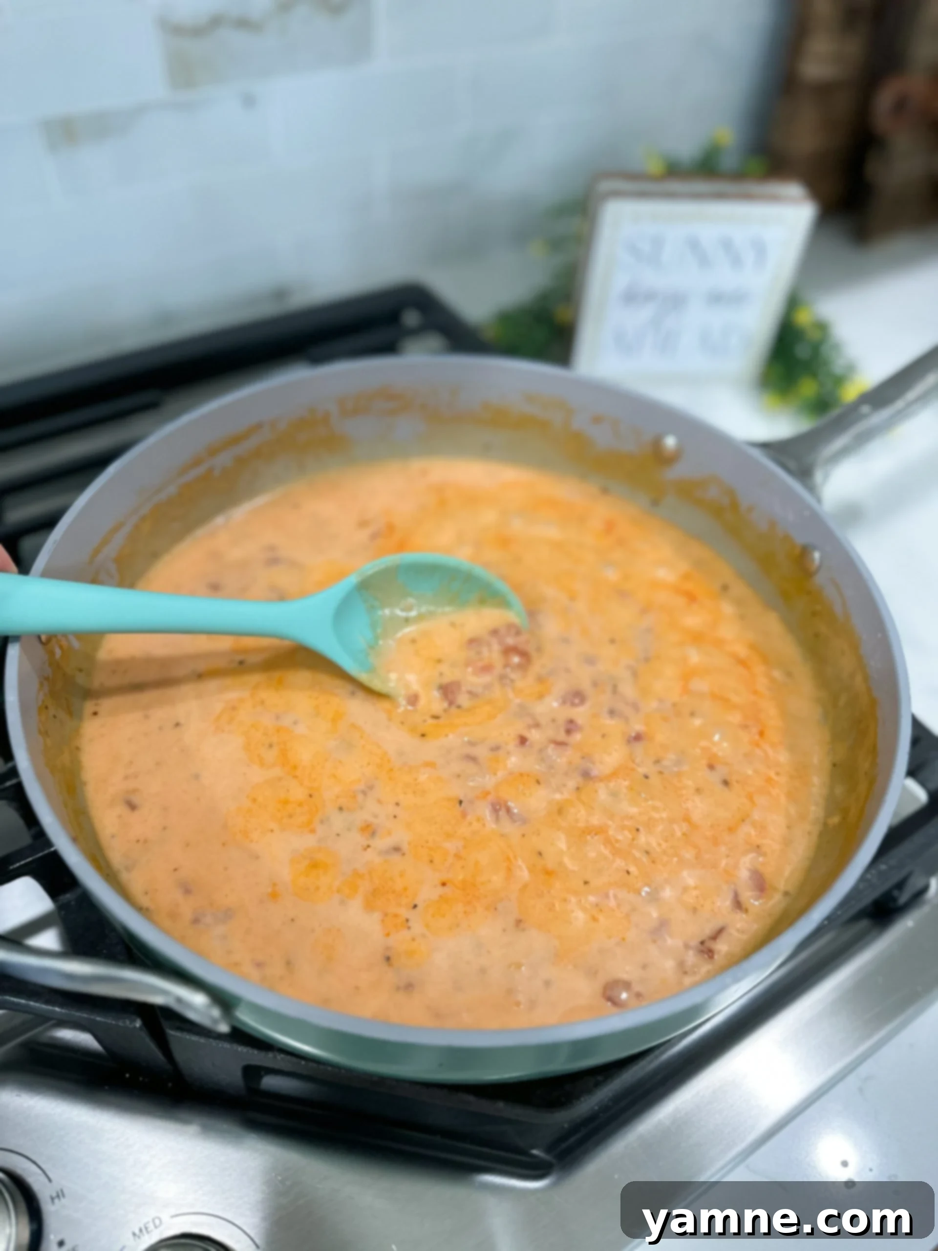 Smoky Bacon Tomato Cream Pasta 6 Alfredo and tomato sauce simmering in a skillet