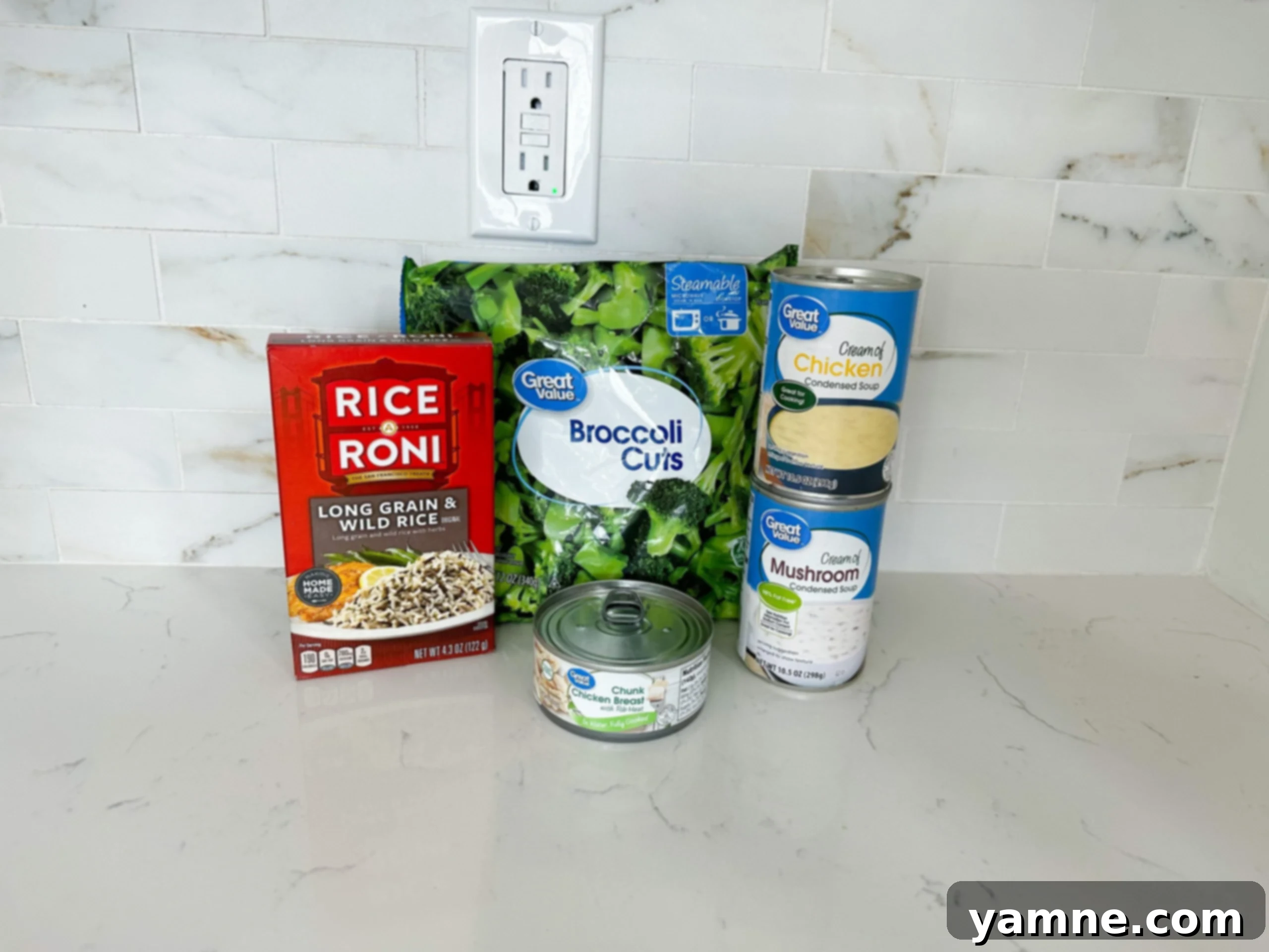 Ingredients for chicken and rice casserole including soups, broccoli, and rice mix