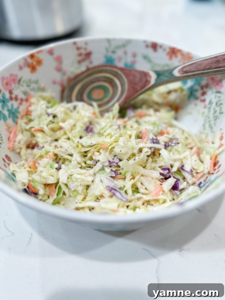 Close-up of fresh, shredded cabbage and carrots, the base for a delicious homemade coleslaw.