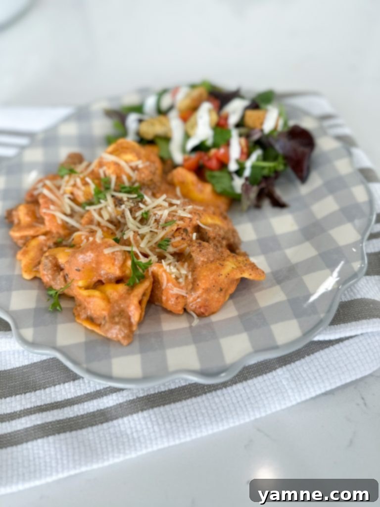 Easy Cheesy TikTok Tortellini 3 Close-up of cubed cream cheese, shredded mozzarella, and Italian seasoning, key ingredients for creamy tortellini sauce.